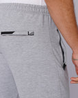 close-up of light grey travel pants rear zipper pocket and waistband