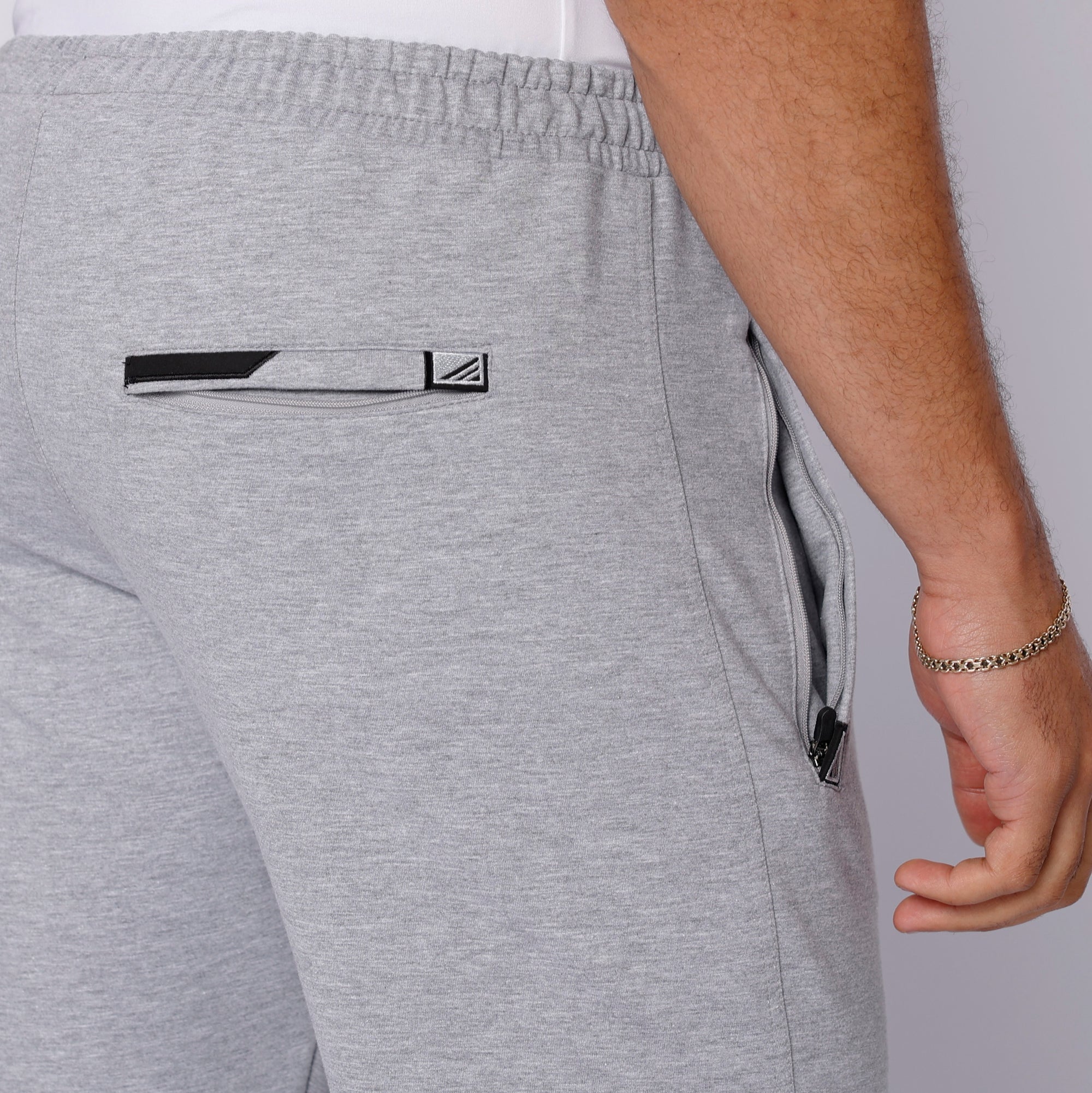 close-up of light grey tall men’s sweat pants with back zipper pocket