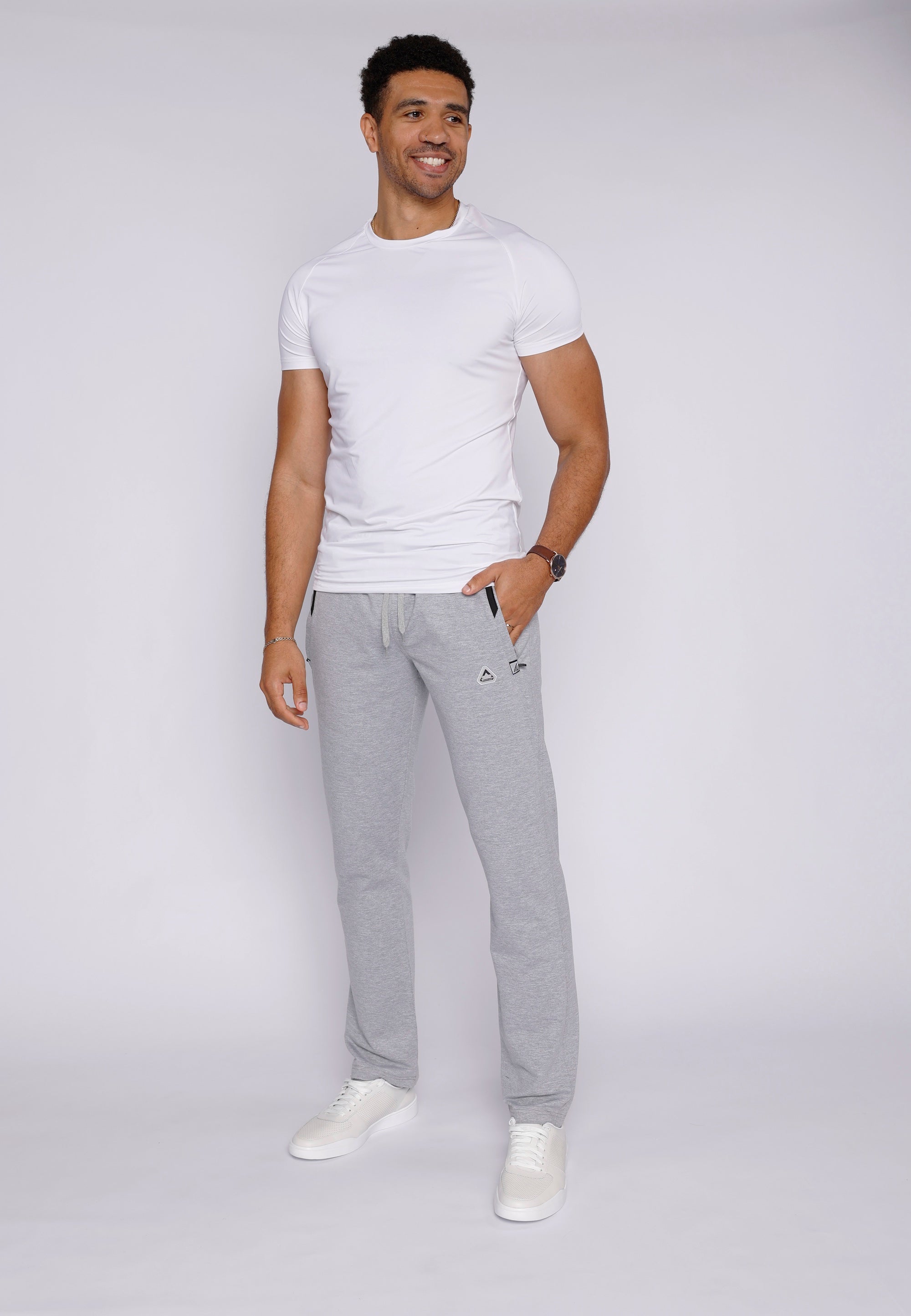 tall confident male model wearing light grey long-inseam athletic sweat pants, lifestyle view

