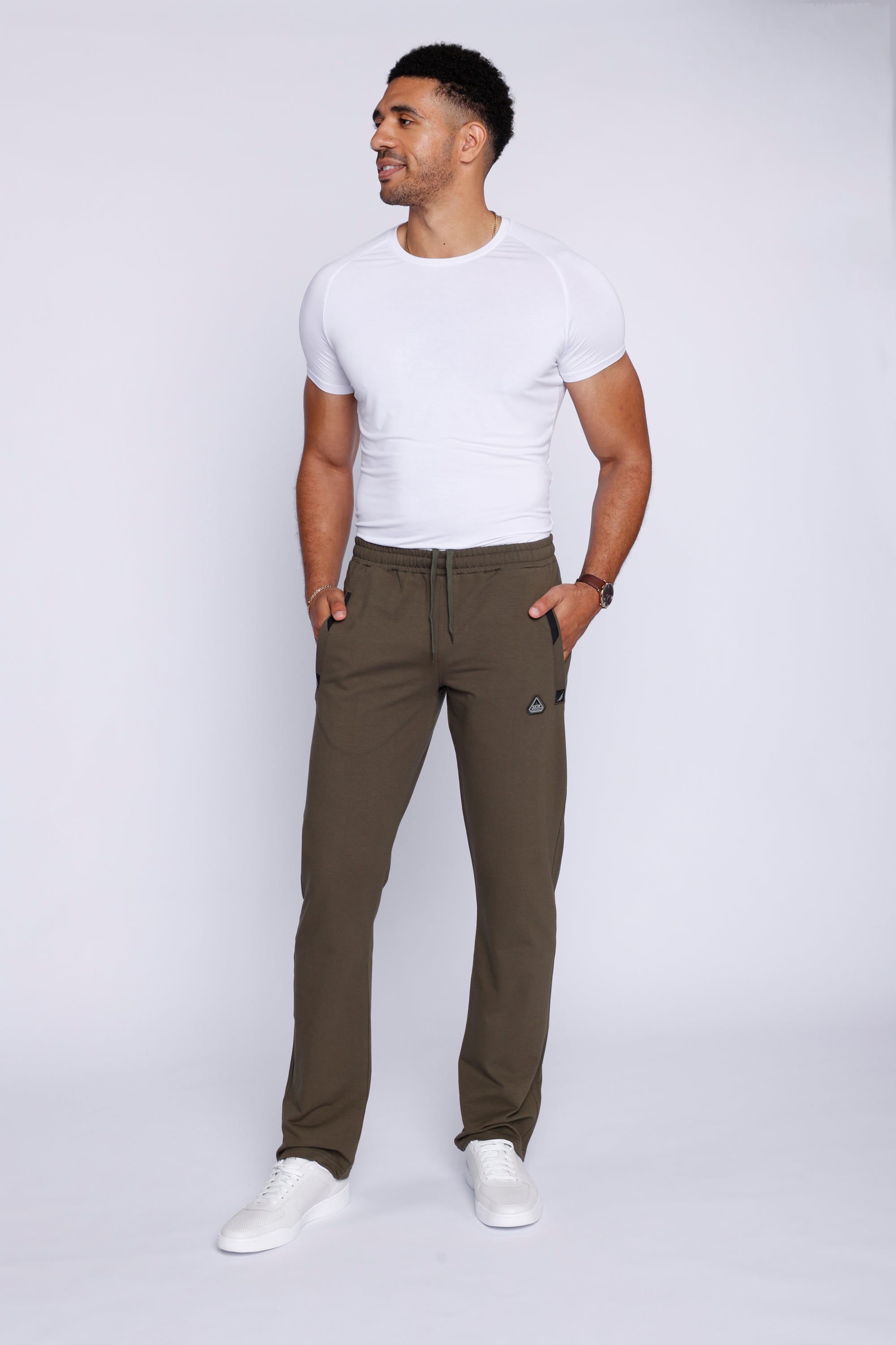 man wearing khaki green athletic pants in studio lifestyle view