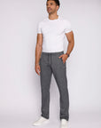 man wearing heather grey sweatpants and white sneakers, lifestyle image