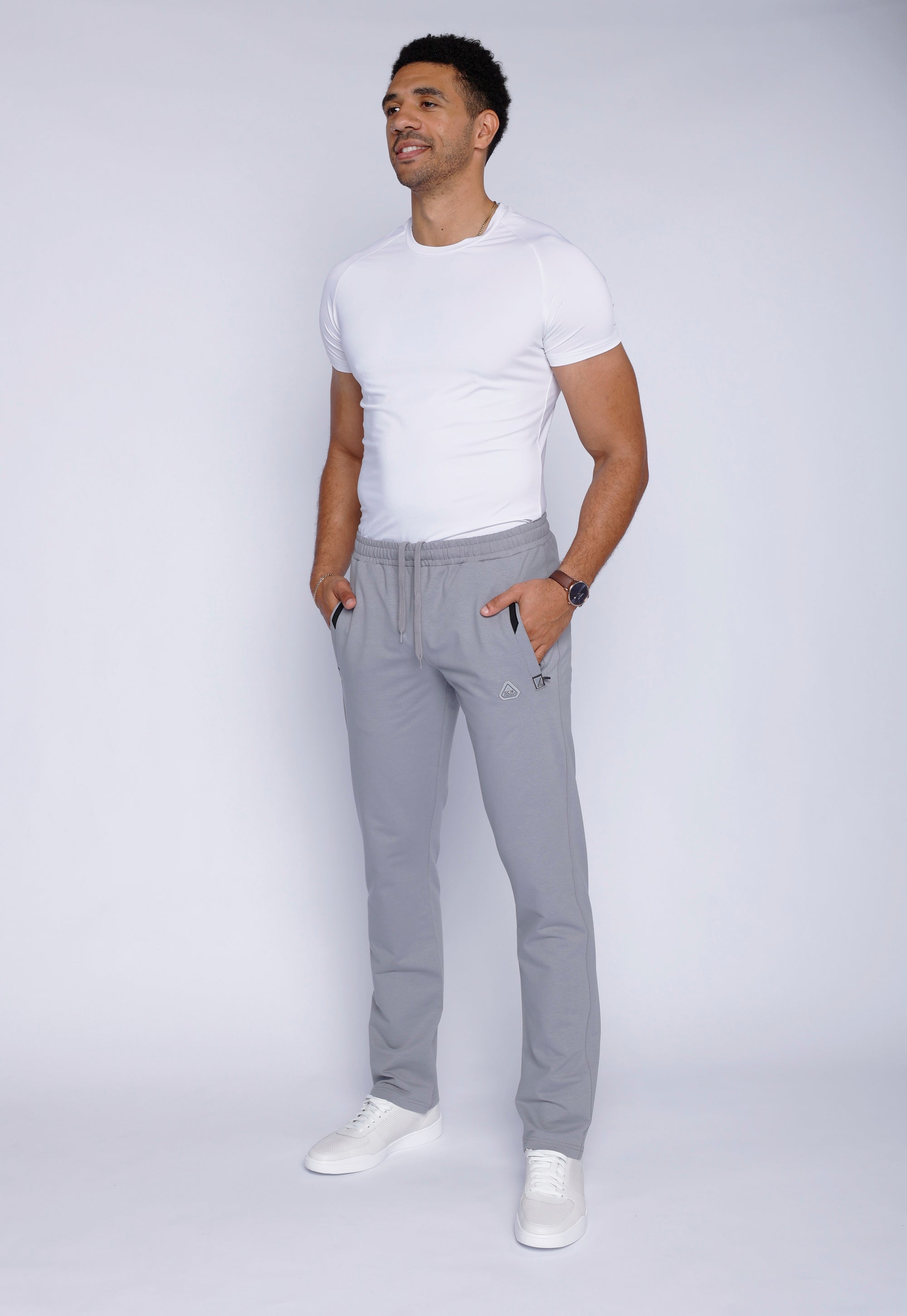 tall male model wearing grey long inseam athletic sweatpants, lifestyle full-body view
