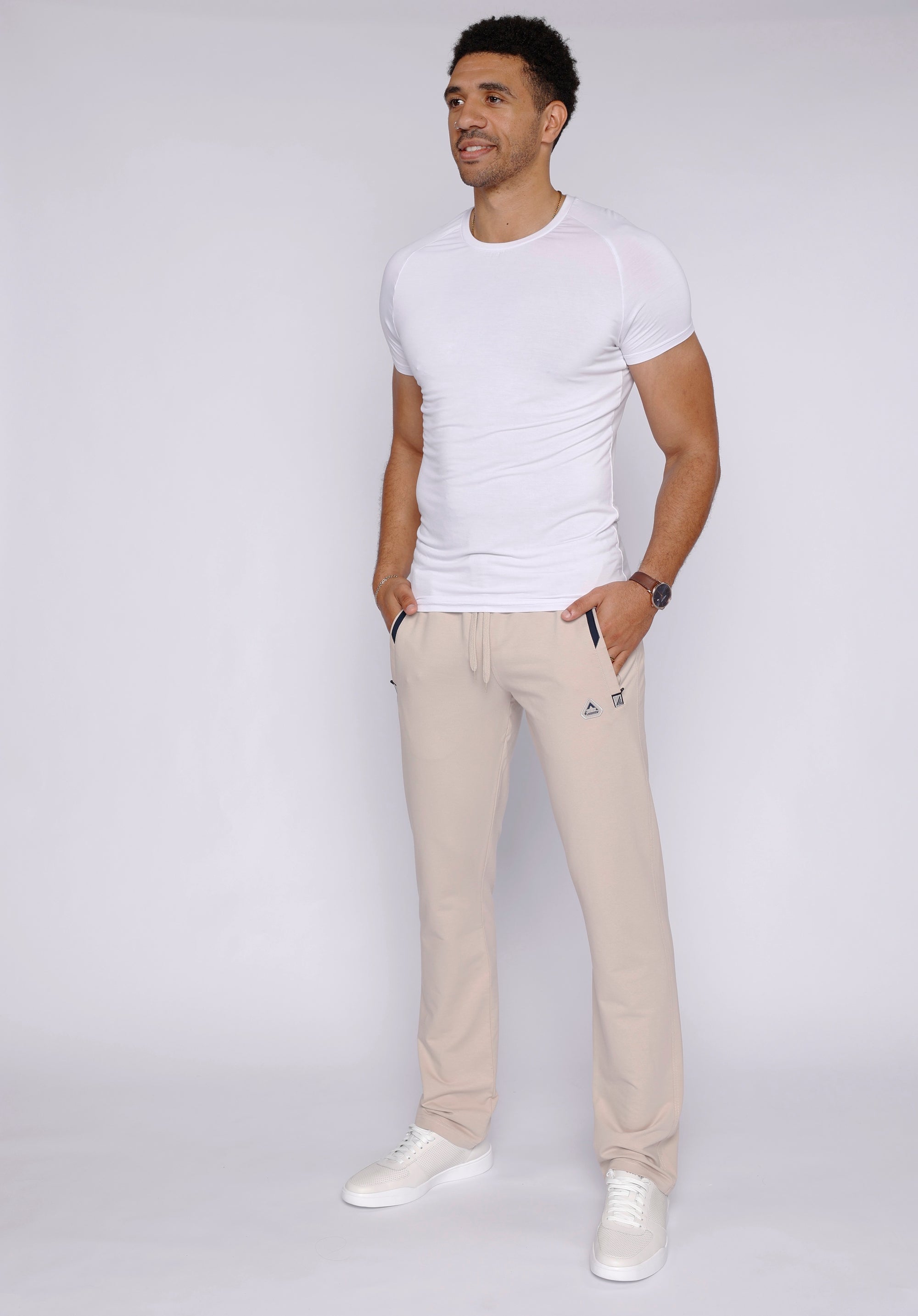 man wearing beige athletic pants in lifestyle setting