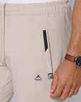 close-up of beige athletic pants front zipper pocket
