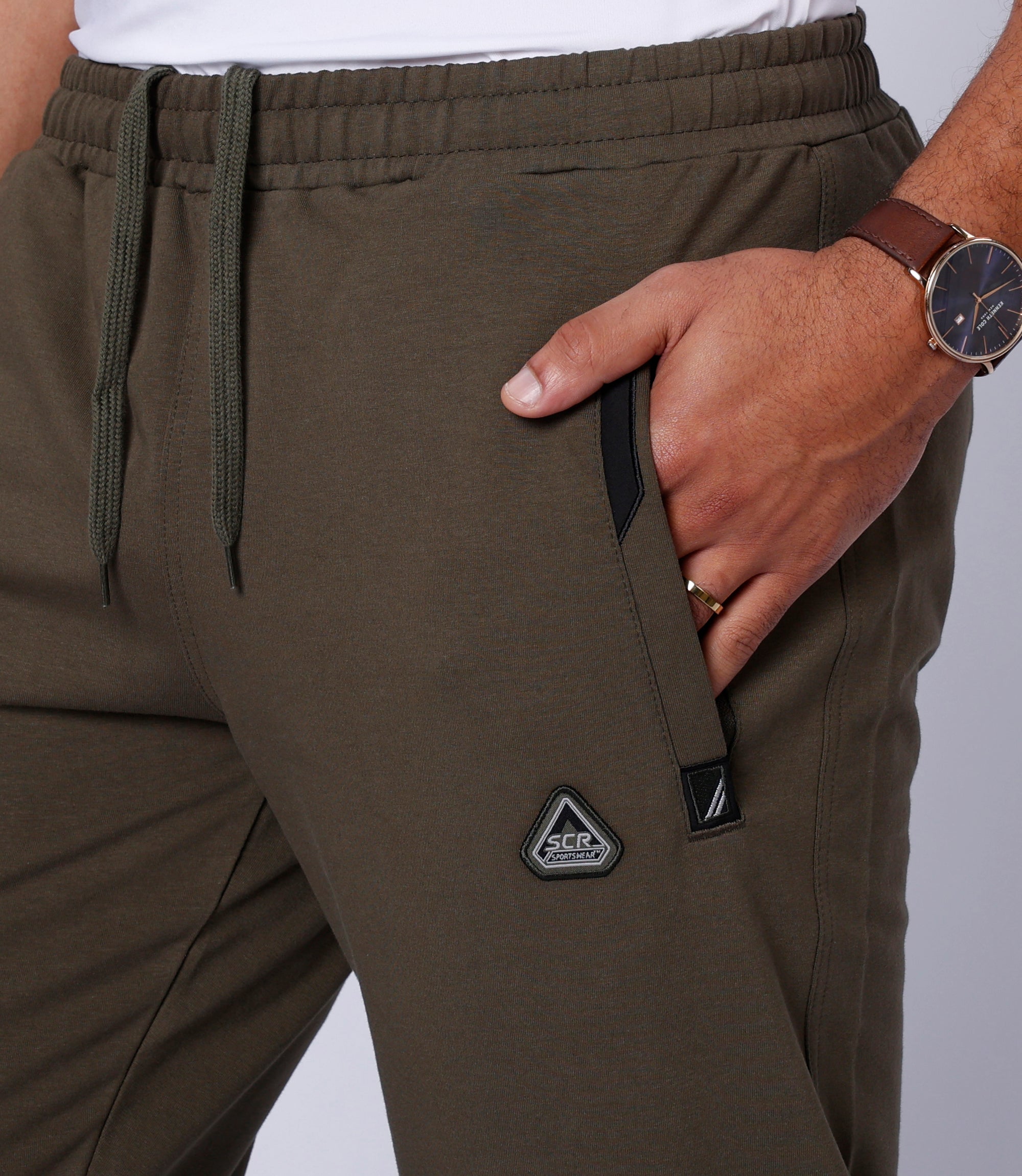 close-up of khaki green tall men’s athleisure lounge pants showing front zipper pocket