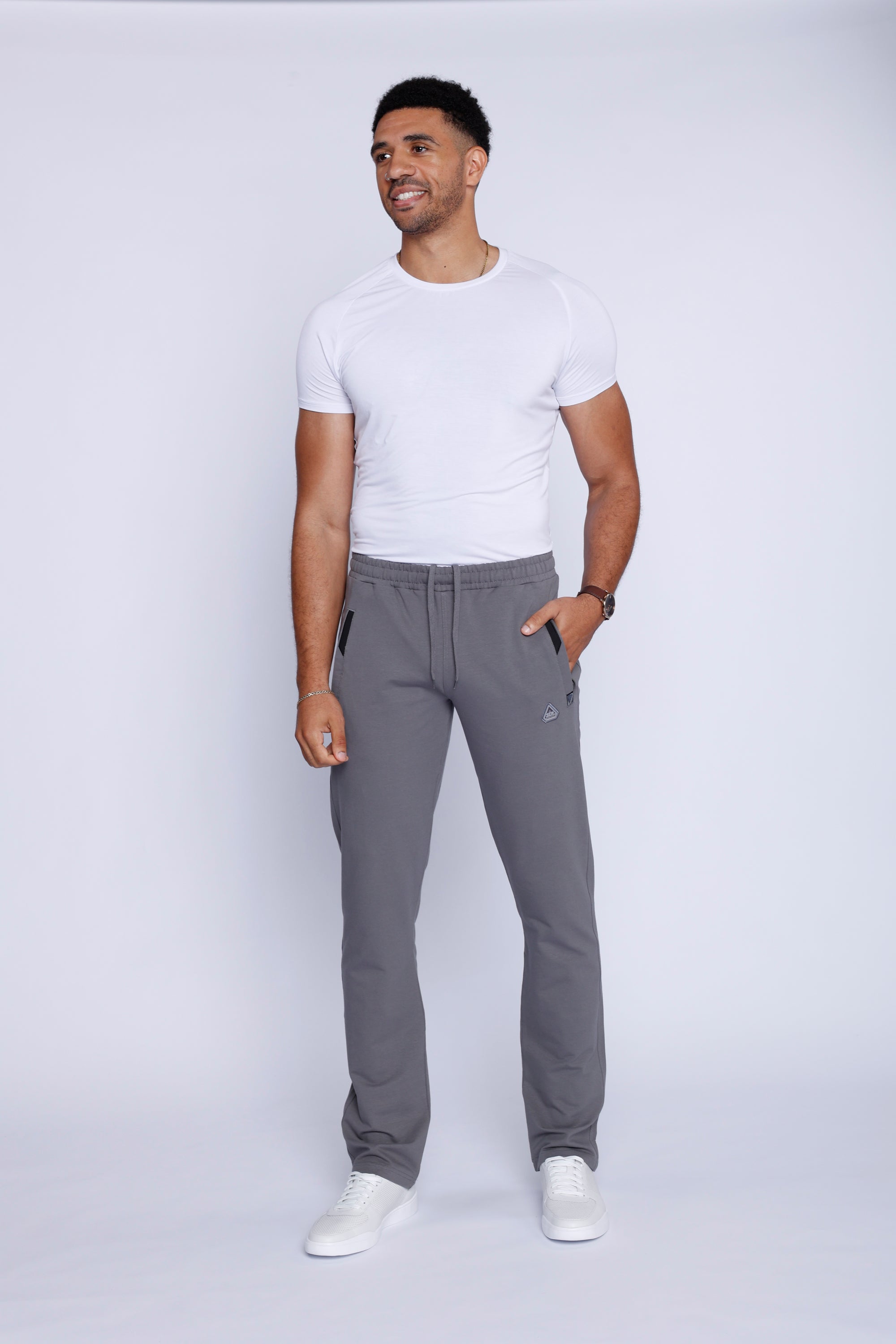  men’s light grey sweatpants straight leg style, full-length lifestyle view worn by male model.