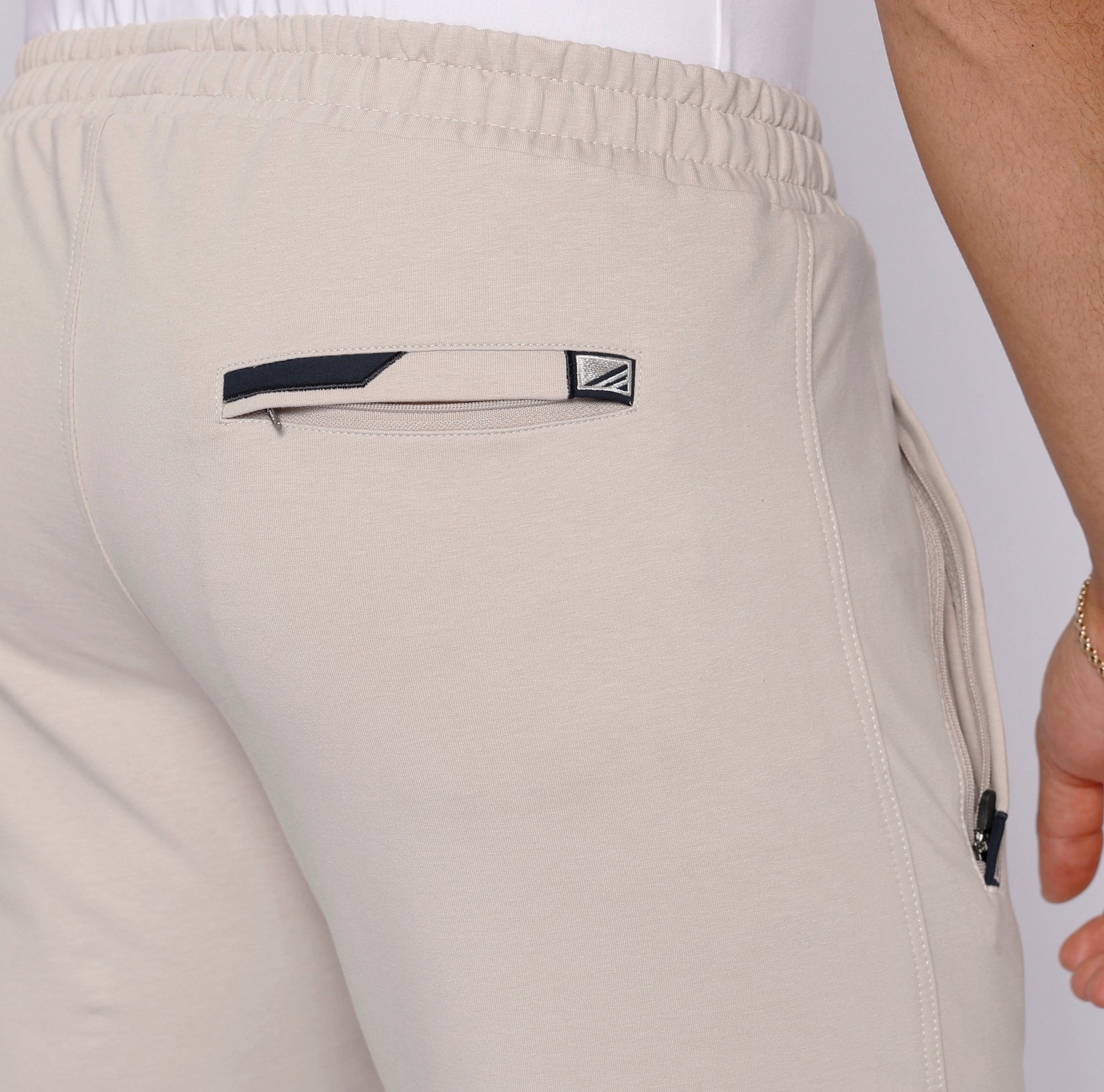 close-up of beige athletic pants back zipper pocket