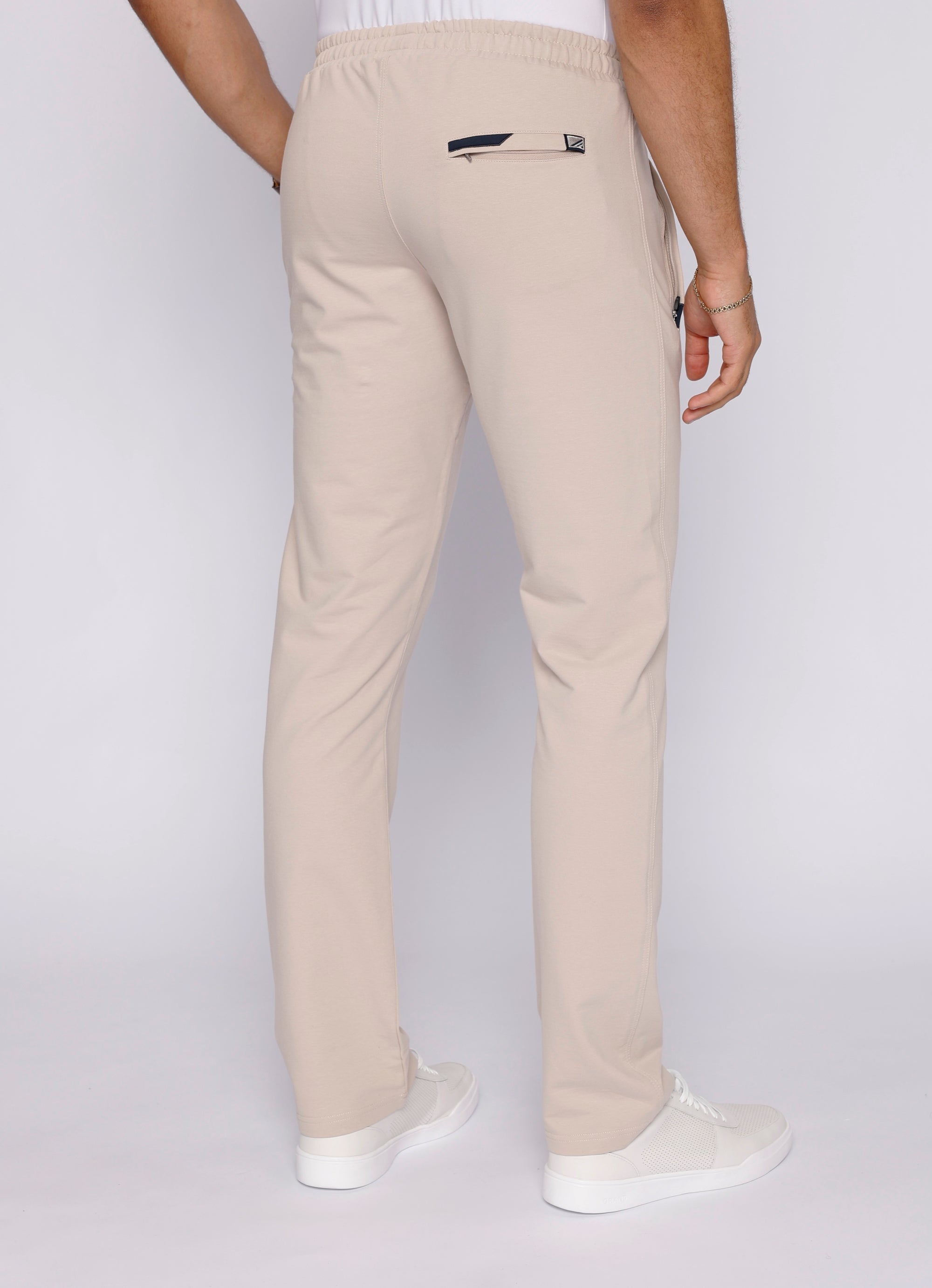 men’s beige athletic pants with clean athletic cut, back view