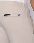 close-up of tall men’s beige sweatpants showing secure back zipper pocket